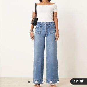 ASOS Petite high rise wide leg jeans with front pockets in mid blue